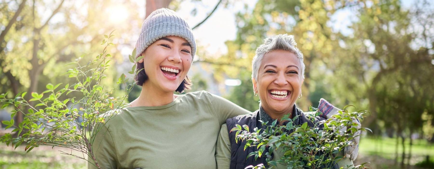 a couple of women holding plants