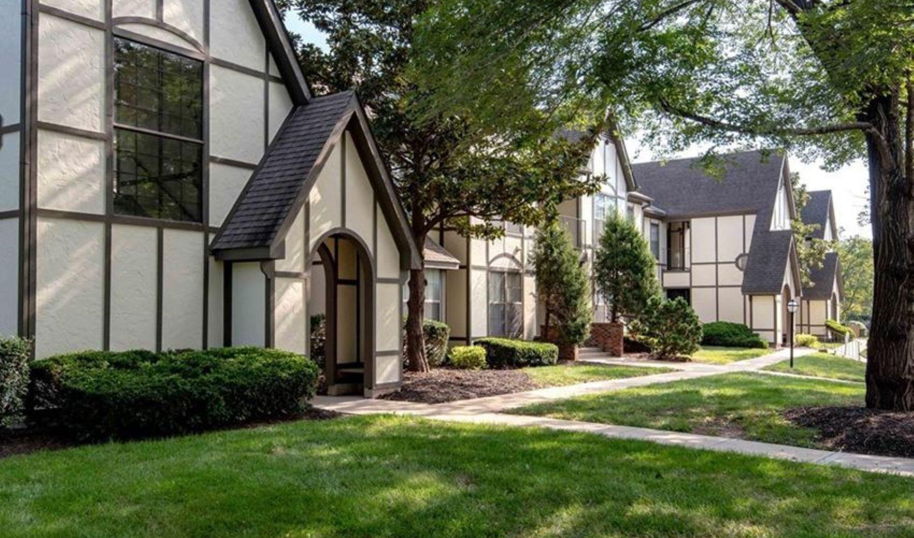 a building with a lawn and trees